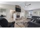 Living room with vaulted ceilings, a sectional sofa, and a stone fireplace at 603 Plantation Dr., Surfside Beach, SC 29575