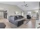 Open living room with L-shaped sectional sofa, hardwood floors, and a view of the kitchen at 603 Plantation Dr., Surfside Beach, SC 29575