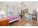 Cozy bedroom featuring a purple quilt and hardwood floors at 648 Twinflower Dr., Little River, SC 29566