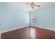 Light blue bedroom with hardwood floors and ceiling fan at 6803 E Highway 19, Loris, SC 29569