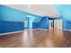 Spacious bonus room with blue walls and hardwood floors at 6803 E Highway 19, Loris, SC 29569