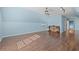 Large bonus room with light blue walls and hardwood floors at 6803 E Highway 19, Loris, SC 29569