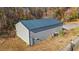 Tan metal storage shed with dark gray roof at 6803 E Highway 19, Loris, SC 29569