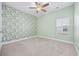 Bedroom with tropical-themed wallpaper and carpeted flooring at 692 Cherry Blossom Dr., Murrells Inlet, SC 29576