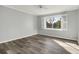 Bright bedroom with grey walls, wood-look flooring, and window shutters at 800 Egret Circle # 57, Little River, SC 29566