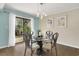 Charming dining area with glass-top table and four chairs near the patio at 800 Egret Circle # 57, Little River, SC 29566