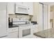 Well-equipped kitchen featuring white appliances and granite countertops at 800 Egret Circle # 57, Little River, SC 29566