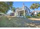 Spacious backyard featuring a deck, lush green grass, and mature trees at 820 9Th Ave. S, North Myrtle Beach, SC 29582