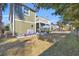 Expansive backyard featuring a deck, lush green grass, and mature trees at 820 9Th Ave. S, North Myrtle Beach, SC 29582