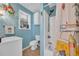 Coastal themed bathroom boasts a shower-tub combo, a vanity, and blue painted walls at 820 9Th Ave. S, North Myrtle Beach, SC 29582