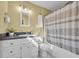 Well lit bathroom featuring a shower-tub combo, granite countertops, and sleek white cabinets at 820 9Th Ave. S, North Myrtle Beach, SC 29582