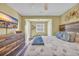 A cozy bedroom is adorned with a ceiling fan, a wooden dresser with TV, and a window seat at 820 9Th Ave. S, North Myrtle Beach, SC 29582