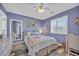 Charming bedroom with blue walls, plantation shutters, and beach-themed decor at 820 9Th Ave. S, North Myrtle Beach, SC 29582