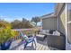 Inviting deck with wicker furniture, plush cushions, potted palms, and blue skies at 820 9Th Ave. S, North Myrtle Beach, SC 29582