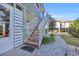 Exterior view of raised beach home with stairs, landscaping, and partial ocean view at 820 9Th Ave. S, North Myrtle Beach, SC 29582