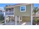 A charming beach house on stilts with a screened porch, painted in a calming shade of green at 820 9Th Ave. S, North Myrtle Beach, SC 29582