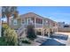 Attractive raised beach house, with a covered area under the house and stairs to a screened-in porch at 820 9Th Ave. S, North Myrtle Beach, SC 29582