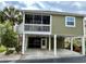 Charming raised beach home with a carport, a screened porch, and a landscaped yard at 820 9Th Ave. S, North Myrtle Beach, SC 29582