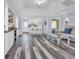 Inviting living room boasts vaulted ceilings, stylish flooring, and a cozy electric fireplace at 820 9Th Ave. S, North Myrtle Beach, SC 29582