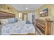 Inviting main bedroom featuring beach themed decor, ceiling fan, and a wooden dresser with a wall mounted TV at 820 9Th Ave. S, North Myrtle Beach, SC 29582