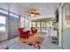 Relaxing screened-in porch featuring red chairs and vibrant rug for outdoor living at 820 9Th Ave. S, North Myrtle Beach, SC 29582