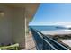 Balcony showcasing green Adirondack chairs and table facing sunny ocean and pier view at 8560 Queensway Blvd. # 706, Myrtle Beach, SC 29572