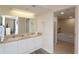 Bathroom with double sinks, a large mirror, and access to a bathtub at 8560 Queensway Blvd. # 706, Myrtle Beach, SC 29572