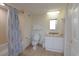 Bright bathroom featuring a single vanity with a mirror, bathtub with shower curtain, and toilet at 8560 Queensway Blvd. # 706, Myrtle Beach, SC 29572