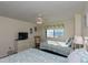 Bedroom features two beds, TV on dresser, ceiling fan, and bright window with ocean view at 8560 Queensway Blvd. # 706, Myrtle Beach, SC 29572