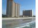 Exterior view of an oceanfront condo complex with balconies and beach access at 8560 Queensway Blvd. # 706, Myrtle Beach, SC 29572
