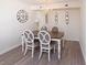 Charming dining room with a wooden table and four chairs, complemented by wall decor at 8560 Queensway Blvd. # 706, Myrtle Beach, SC 29572