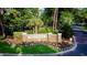 Kingston Plantation entrance with a brick sign, lush greenery, and colorful flowerbeds at 8560 Queensway Blvd. # 706, Myrtle Beach, SC 29572