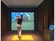 Personal playing virtual golf in a state-of-the-art golf simulator room at 8560 Queensway Blvd. # 706, Myrtle Beach, SC 29572