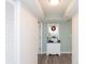 Inviting condo entryway featuring calming blue accent wall, sleek hardwood floors, and convenient storage at 8560 Queensway Blvd. # 706, Myrtle Beach, SC 29572