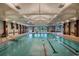 Large indoor swimming pool with marked lanes, recreational area, and ample lighting at 8560 Queensway Blvd. # 706, Myrtle Beach, SC 29572