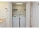 Laundry closet featuring a stacked washer and dryer, with a shelf and cleaning supplies at 8560 Queensway Blvd. # 706, Myrtle Beach, SC 29572