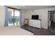 Spacious main bedroom with balcony access, dresser, and a comfortable chair at 8560 Queensway Blvd. # 706, Myrtle Beach, SC 29572
