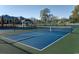 Community pickleball court with new blue surface, surrounding fence, and gazebo at 8560 Queensway Blvd. # 706, Myrtle Beach, SC 29572