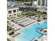 Aerial view of a large outdoor pool with lounge chairs, umbrellas, and manicured palm trees at 8560 Queensway Blvd. # 706, Myrtle Beach, SC 29572