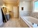 Bathroom featuring marble flooring, tub, vanity with marble countertop, and crown molding at 926 Eula Dr., Conway, SC 29526