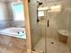 Bathroom featuring a glass shower door, a soaking tub, and marble countertops at 926 Eula Dr., Conway, SC 29526