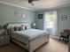 Light bedroom features a large bed, fan and bright window at 926 Eula Dr., Conway, SC 29526