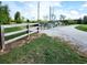 View of front gate leading to a long gravel driveway and home in the distance at 926 Eula Dr., Conway, SC 29526