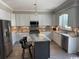 Modern kitchen features stainless steel appliances, island with seating, and granite countertops at 926 Eula Dr., Conway, SC 29526