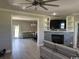 Bright living room features a fireplace, built-in shelving, and sleek gray flooring at 926 Eula Dr., Conway, SC 29526