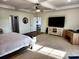 Serene main bedroom featuring a large bed, ceiling fan, and a glimpse into an adjacent room at 926 Eula Dr., Conway, SC 29526