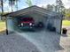 Large metal shed with Jeep and lawnmower parked on the gravel covered floor at 926 Eula Dr., Conway, SC 29526