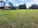 Expansive green yard featuring the side of a light blue home and landscaping at 926 Eula Dr., Conway, SC 29526