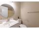 Neat bathroom featuring a white vanity with a round mirror, offering a clean and modern design at 1100 Possum Trot Rd. # H234, North Myrtle Beach, SC 29582