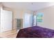 Bright bedroom with a wooden dresser, a comfortable bed and a large window offering a peaceful view at 1100 Possum Trot Rd. # H234, North Myrtle Beach, SC 29582